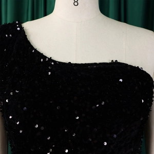 Close-up of black sequins texture on an elegant one-shoulder formal evening gown
