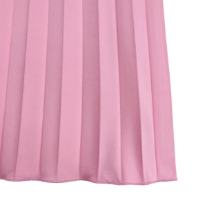 Detail of pink pleated wide-leg pants showing fine pleat texture and hem stitching
