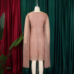 Detail of rose gold pleated evening dress featuring elegant cape sleeves and back zipper