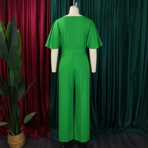 Detail view of the back of a bright green wide-leg jumpsuit with high waist and back zipper