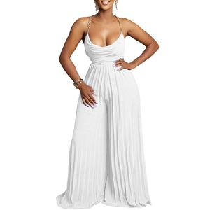 Detail of white pleated jumpsuit featuring a gold chain halter strap and draped neckline