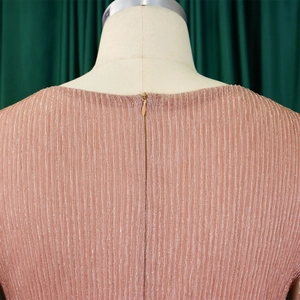 Detail of elegant metallic rose gold pleated dress showing the invisible back zipper closure