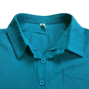 Detail of shirt lapel collar with buttons, chest pocket and lake blue fabric texture