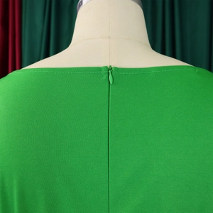 Close-up of green jumpsuit back with high-quality invisible zipper and fine stitching