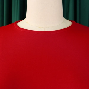 Close-up of the elegant round neckline and pleated texture of the red evening party dress