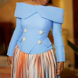 Detail of off-shoulder top with floral pearl buttons and gradient pleated skirt