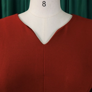 Detail shot of a dark red V-neckline dress featuring pleated 3/4 sleeves and woven texture