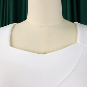 Detail of elegant white off-shoulder neckline with ruffle trim on formal dress