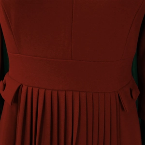 Detail of dark red pleated dress showing waist cut and decorative pocket flaps