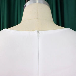 Detail of invisible back zipper closure on the elegant white ruffle dress
