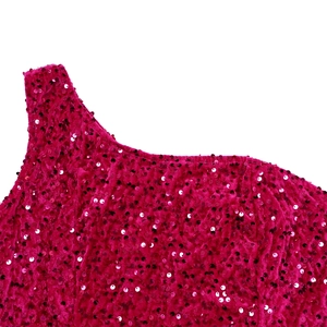 Detail shot of shimmering rose pink sequins and velvet fabric on the one shoulder dress
