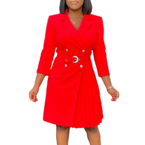 Detail of red blazer dress featuring silver double-breasted buttons and pleated asymmetric hem