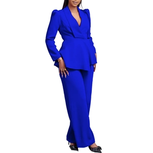 Detail of elegant navy blue two-piece set featuring peplum blazer and wide-leg trousers
