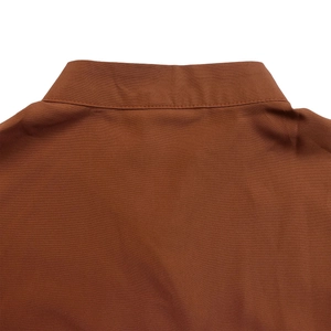 Detail shot of brown cotton shirt collar and back showing clean stitching and fabric texture