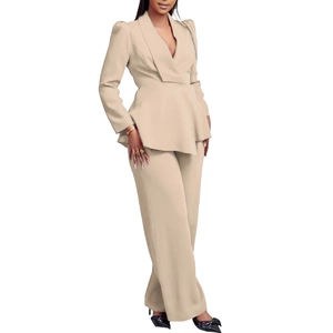Detail of elegant beige peplum blazer with ruffle hem and matching wide-leg trousers
