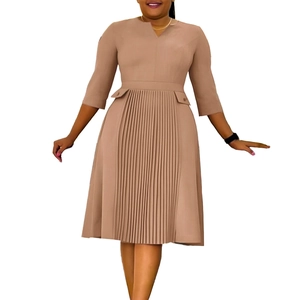 Detail view of khaki dress with elegant pleated front panel and three-quarter sleeves