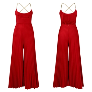 Detail of red halter jumpsuit showing gold chain straps and pleated wide-leg pants