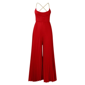 Detail of red pleated jumpsuit featuring elegant gold chain straps and draped cowl neck