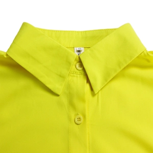 Detail of neon yellow shirt dress collar with buttons and interior size label