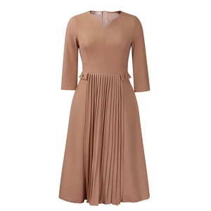 Close-up of elegant V-neckline and button detail on camel pleated midi dress