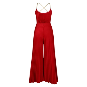 Detail view of red plissé wide-leg jumpsuit with gold chain halter cross straps and pleats
