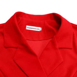 Close-up of red blazer dress notched lapel with texture detail and size M label