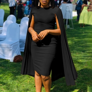 Detail of elegant black sheath dress featuring pleated cape sleeves for evening parties