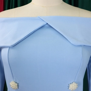 Detail of light blue off-shoulder top with layered collar and pearl waist accents