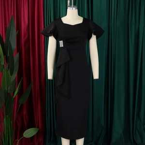 Detail of elegant black sheath dress featuring ruffled cuffs and a silver crystal waist buckle