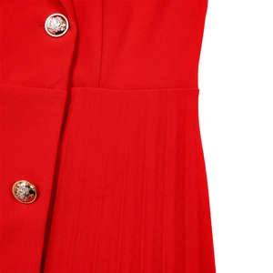 Detail view of red blazer dress featuring ornate gold lion head embossed metal buttons
