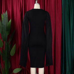 Detail view of the black slim-fit dress featuring unique long pleated sleeves on a mannequin