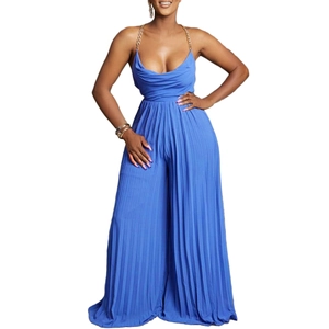 Detail of blue pleated wide-leg jumpsuit with gold chain straps and deep V-neckline