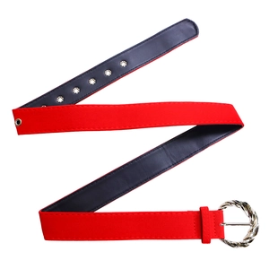Detail of red suede waist belt with silver spiral buckle and metal eyelets on dress