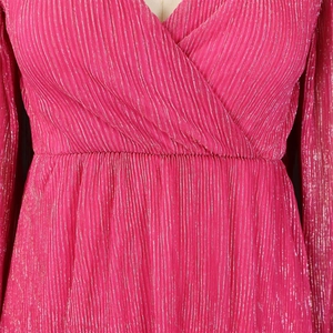 Macro detail of rose red pleated metallic fabric with a V-neck and elastic waist design