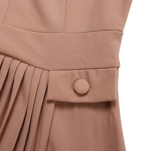 Detail of high waist pleated chiffon dress in dusty rose with fabric covered buttons