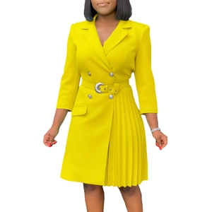 Detail of yellow blazer dress showing pleats, double-breasted buttons and belted waist
