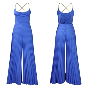Detail of blue halter jumpsuit showing gold chain straps and pleated wide leg fabric