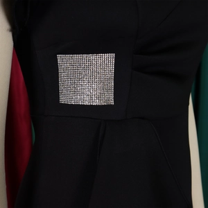 Detail of square silver rhinestone decoration on a black elegant ruffle sheath dress