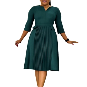 Detail view of V-neckline and pleated hem on this dark green midi dress with 3/4 sleeves