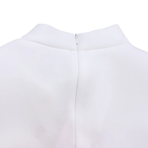 Detail of the high collar and invisible zipper closure on a white evening dress garment