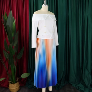 Detail of white off-shoulder top and vibrant orange to blue gradient pleated maxi skirt