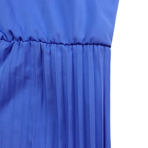 Detailed view of royal blue pleated fabric with sleek waist stitching and sharp folds