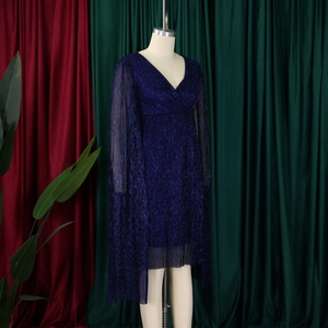 Detail of elegant navy V-neck dress featuring sparkling sequins and pleated cape sleeves