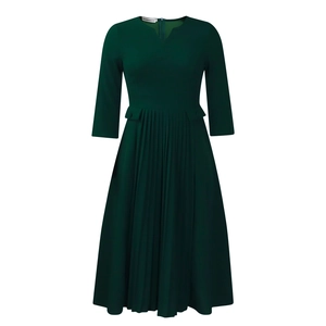 Detail of dark green dress with pleated skirt, three-quarter sleeves and V-neckline