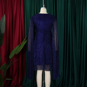 Detail of elegant dark blue party dress with sequin finish and long cape sleeves