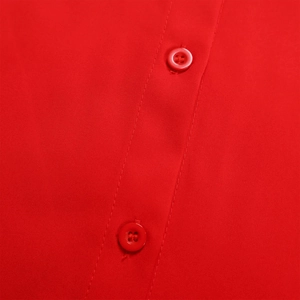 Detailed macro view of high-quality red fabric texture and matching plastic buttons