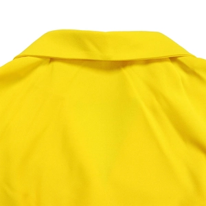 Detailed close-up of high-waist yellow blazer dress neckline with neat stitching texture