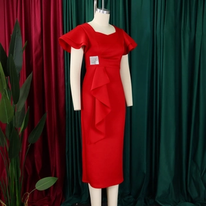 Detailed view of the ruffles on the red dress featuring a silver square sequin accent