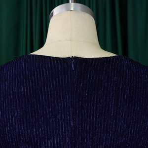 Detail of dark blue pleated fabric with glitter finish and invisible zipper closure
