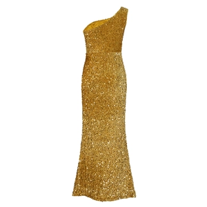 Detailed view of shimmering gold sequins on a one-shoulder evening gown with slit
